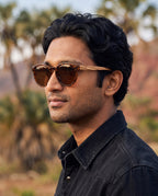 Man wearing Agave Brown sunglasses by Kobe Afrika, close-up