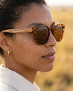 Woman wearing Agave Brown sunglasses by Kobe Afrika, close-up
