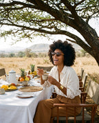 Woman laughing at a bush breakfast in Agave Brown sunglasses by Kobe Afrika
