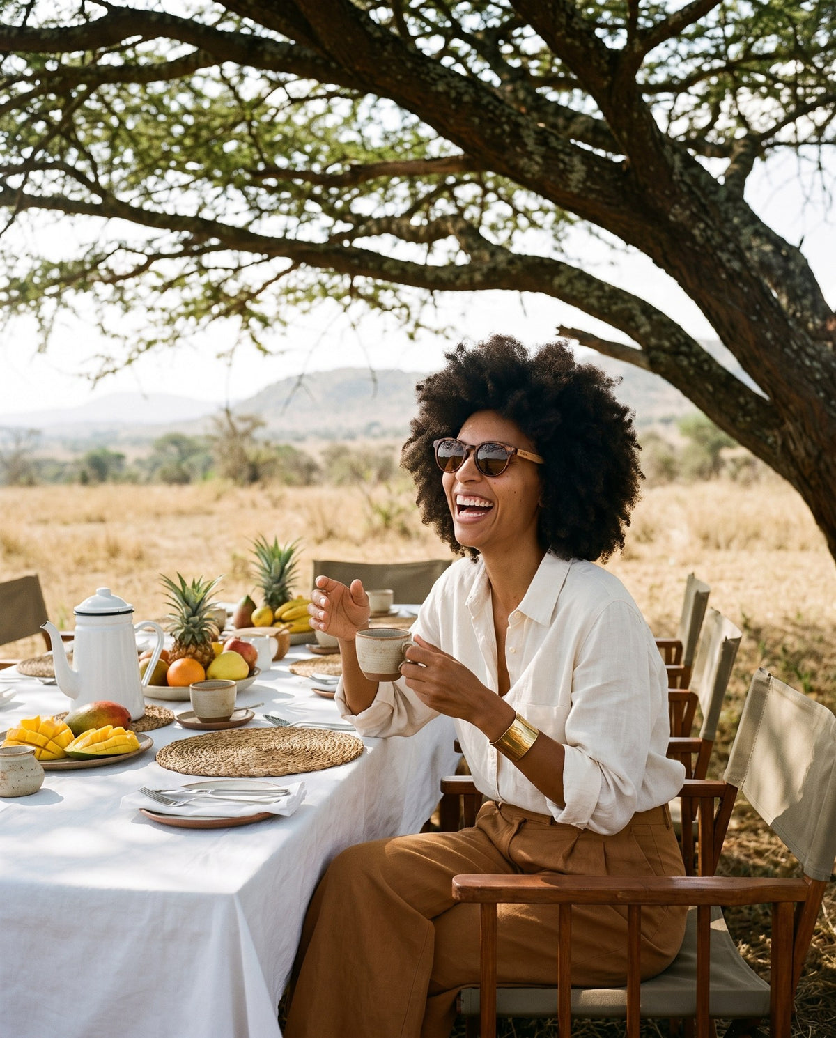 Woman laughing at a bush breakfast in Agave Brown sunglasses by Kobe Afrika