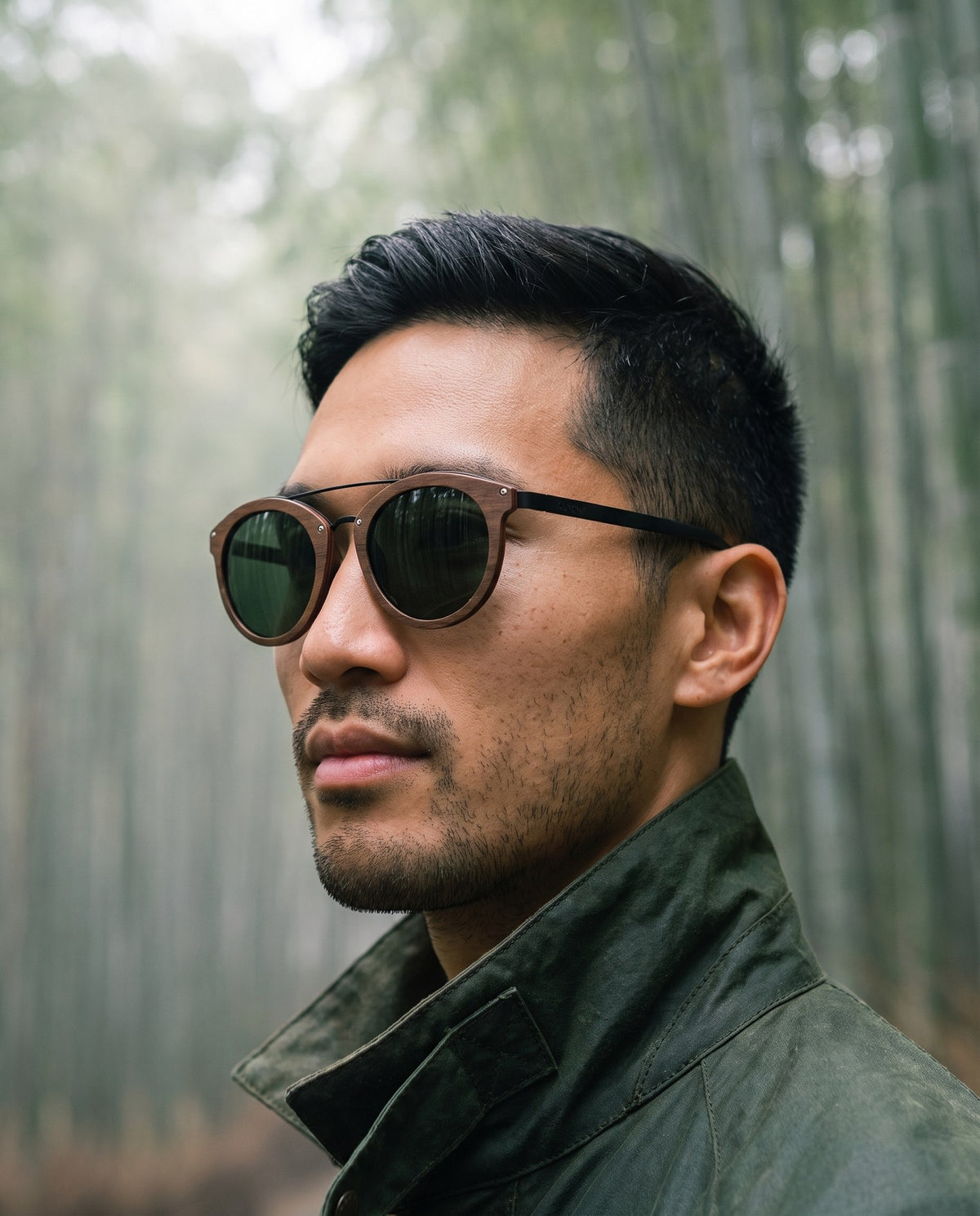 Man wearing Arashi Walnut sunglasses by Kobe Afrika in a bamboo forest, close-up