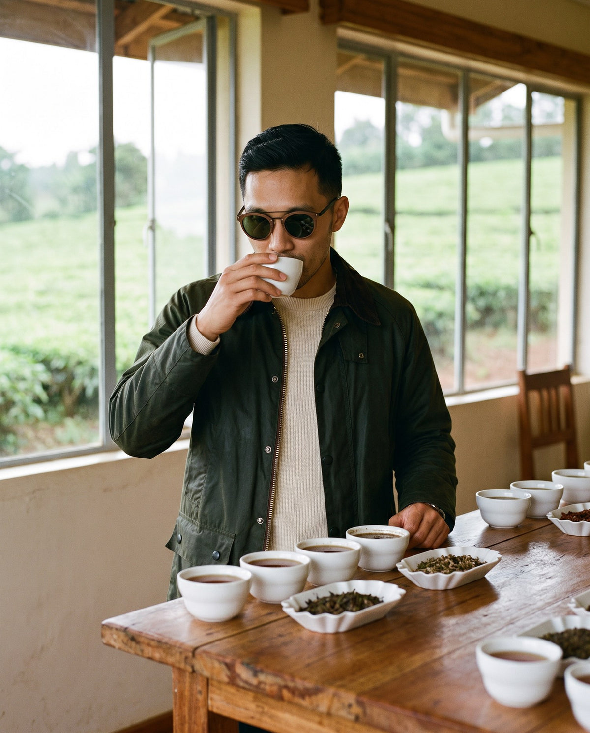 Man tasting tea at a tea factory in Arashi Walnut sunglasses by Kobe Afrika