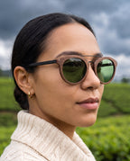 Woman wearing Arashi Walnut sunglasses by Kobe Afrika in tea country, close-up