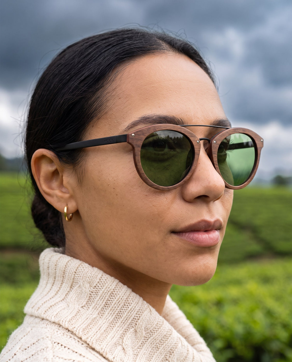 Woman wearing Arashi Walnut sunglasses by Kobe Afrika in tea country, close-up