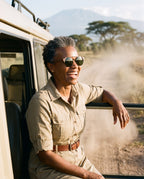 Woman laughing in an open safari vehicle in Atacama Walnut sunglasses by Kobe Afrika