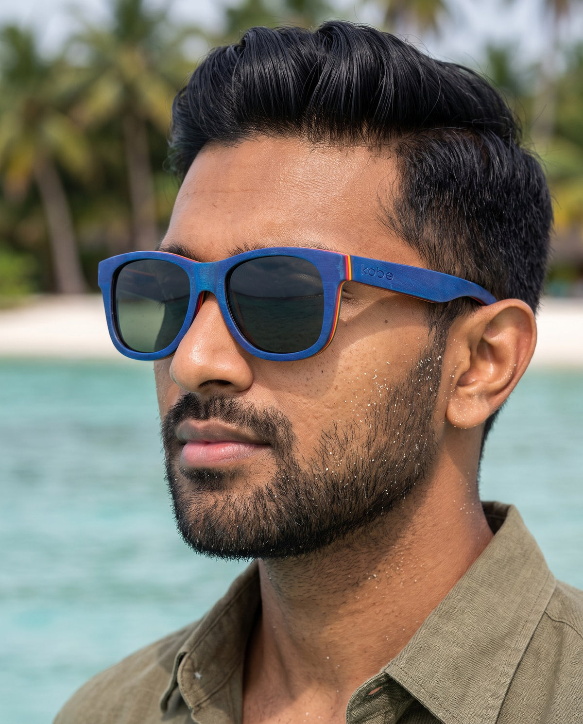 Man wearing Boracay Blue sunglasses by Kobe Afrika by the sea, close-up