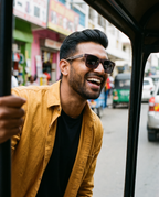 Man laughing from a tuk-tuk on a city street in Borneo Skate Blue sunglasses by Kobe Afrika