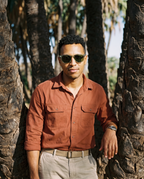 Man among oasis palms in Chalbi Green sunglasses by Kobe Afrika