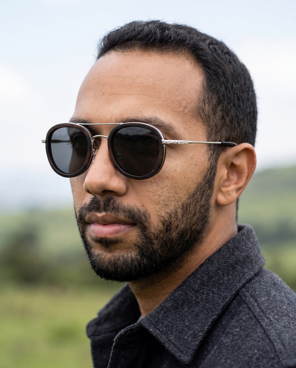 Man wearing Kyzyl Ebony sunglasses by Kobe Afrika, close-up