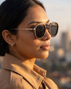 Woman wearing Kyzyl Ebony sunglasses by Kobe Afrika above the city, close-up