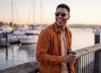 Man with a coffee at the marina in Kyzyl Walnut sunglasses by Kobe Afrika