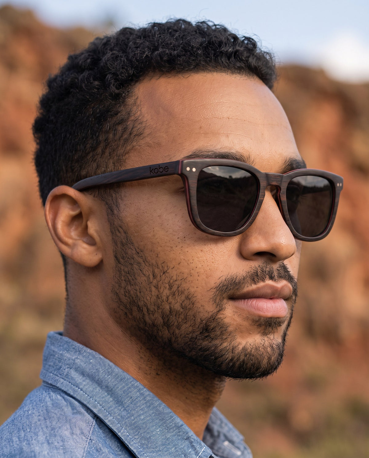 Man wearing Oahu Ebony sunglasses by Kobe Afrika, close-up