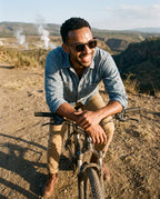 Man on a mountain bike above a geothermal valley in Oahu Ebony sunglasses by Kobe Afrika