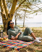 Woman picnicking by a lake in Oahu Ebony sunglasses by Kobe Afrika