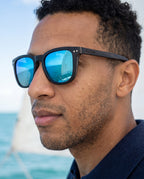 Man wearing Oahu Ocean sunglasses by Kobe Afrika by the sea, close-up