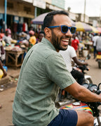 Man on a motorbike through a market in Oahu Skate Blue sunglasses by Kobe Afrika