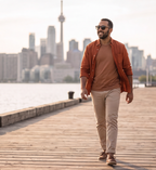 Man walking a waterfront boardwalk in Oahu Walnut sunglasses by Kobe Afrika
