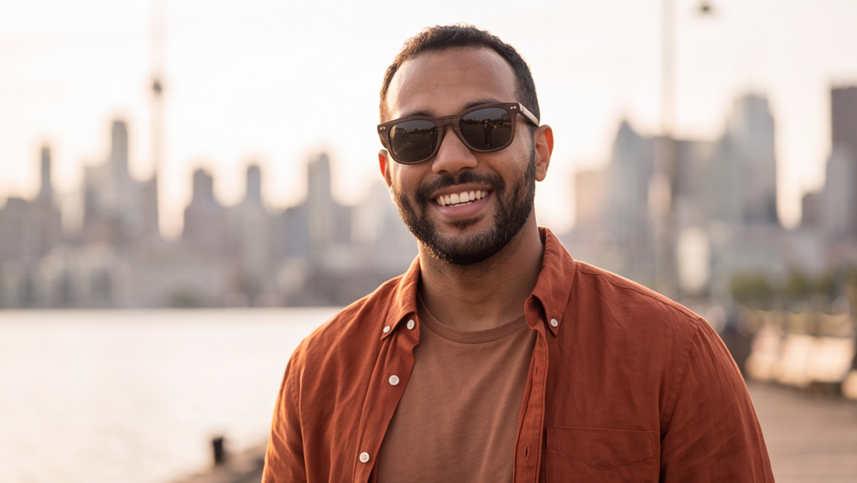 Man on the waterfront wearing Oahu Walnut sunglasses by Kobe Afrika, close-up