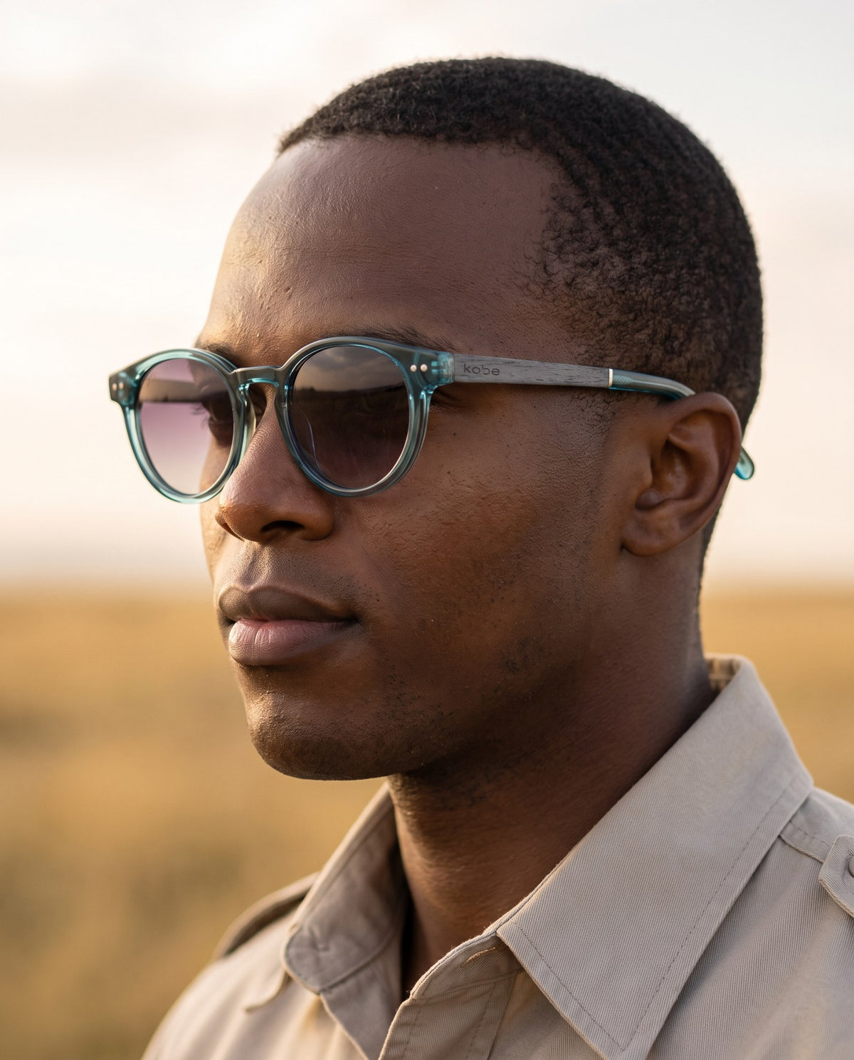 Man wearing Skye Blue sunglasses by Kobe Afrika on the plains, close-up