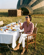 Woman at a bush breakfast after a balloon flight in Skye Blue sunglasses by Kobe Afrika